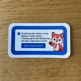 By placing this sticker on my laptop or water bottle, I hereby agree that Mozilla has the best Legal team in tech. With a smiling fox in a tie and a button to agree and continue.